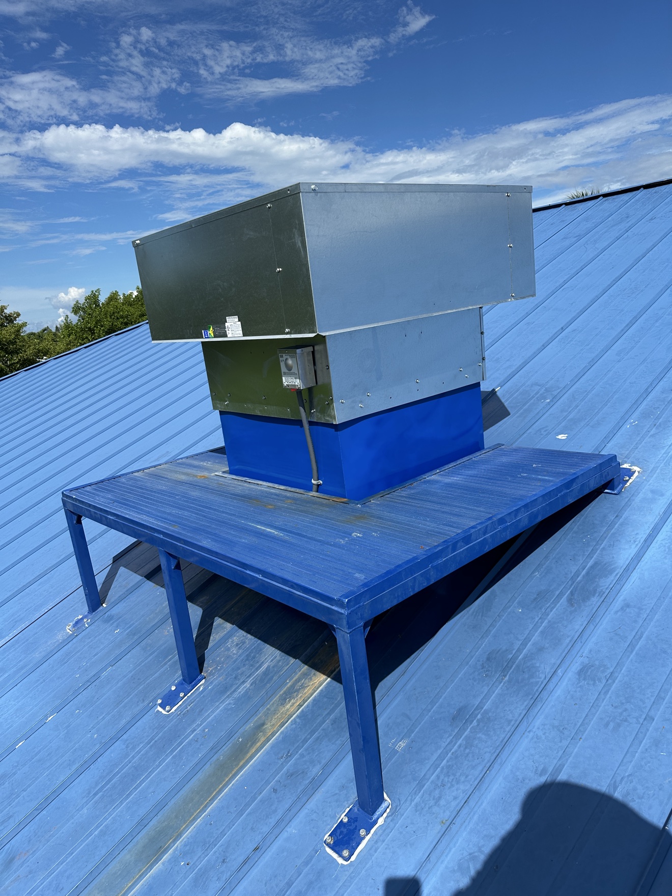 Rooftop HVAC unit on a blue metal roof
