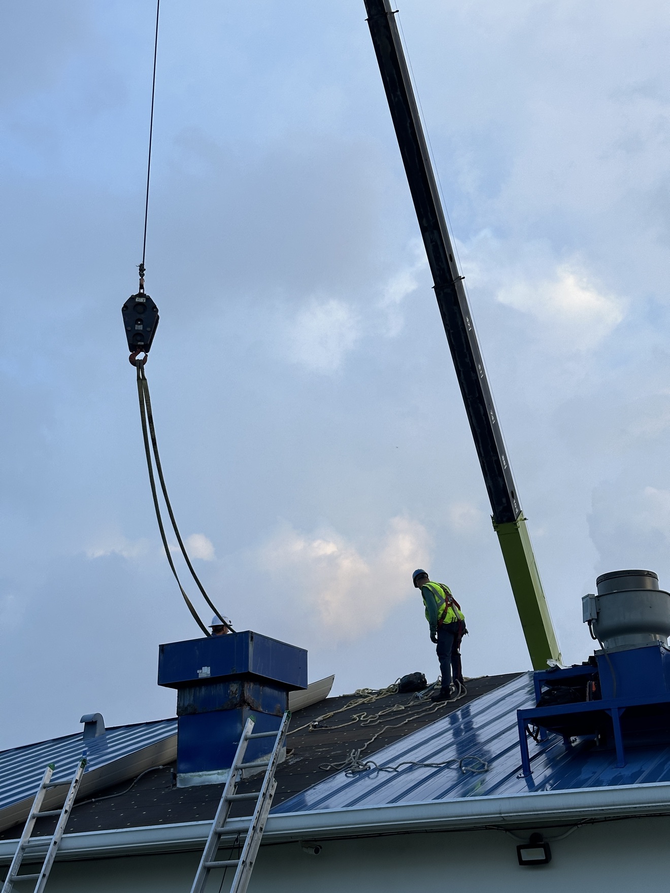 Commercial metal roof with crane lifting equipment