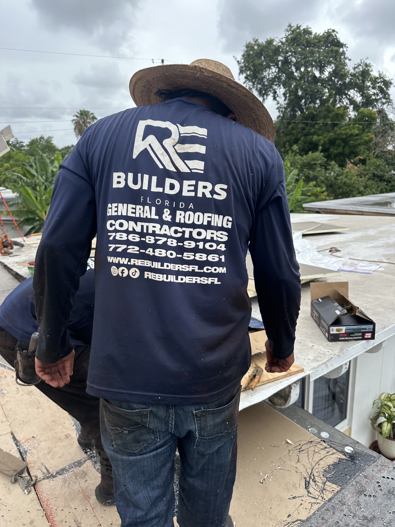 RE Builders worker on a flat roof with insulation boards