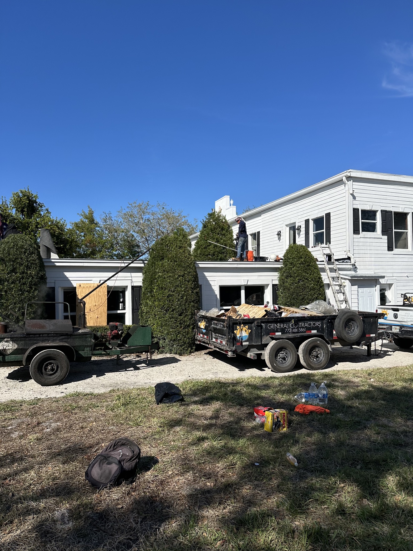 Hot-mop equipment and dump trailer at a flat roof job