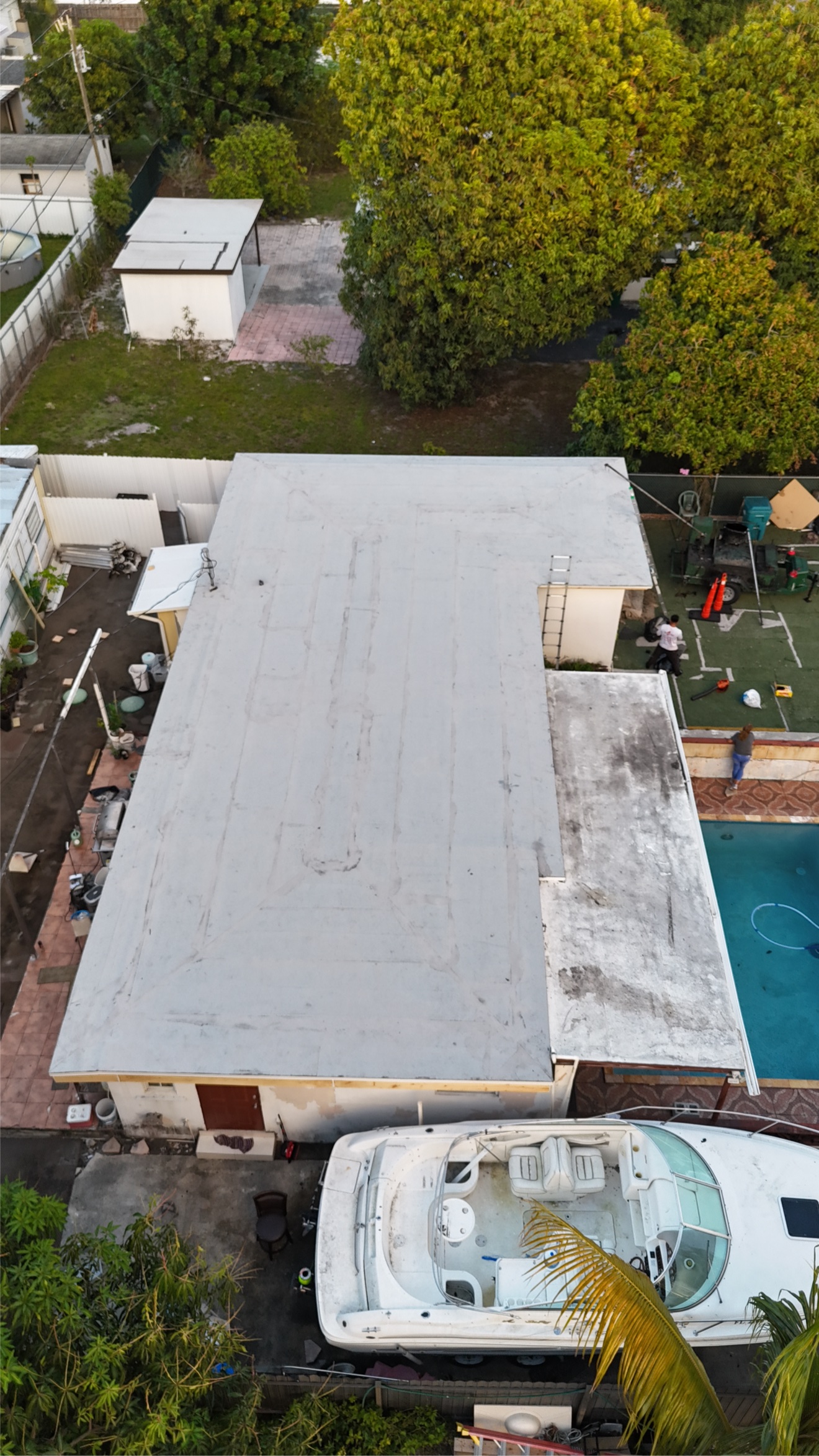 Aerial of a finished flat roof with white cap sheet