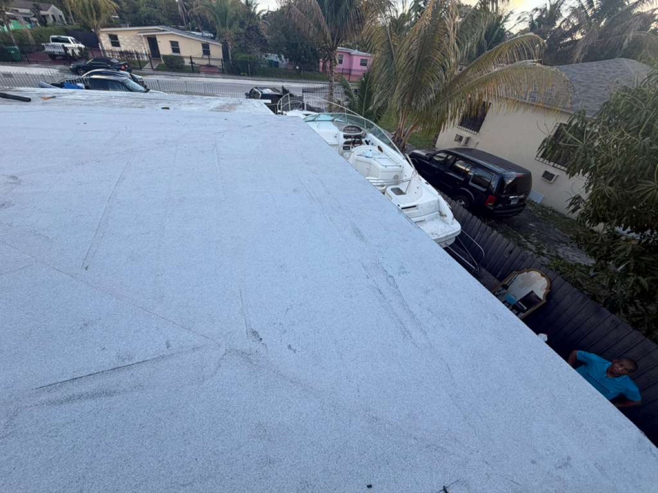 Finished flat roof with a boat beside the house