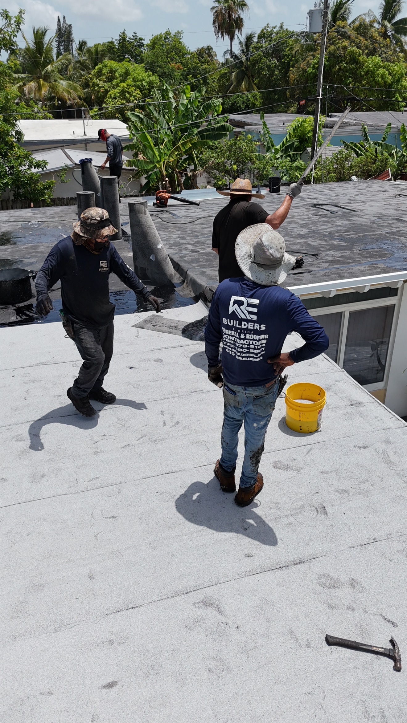 Aerial of a finished flat roof with white cap sheet