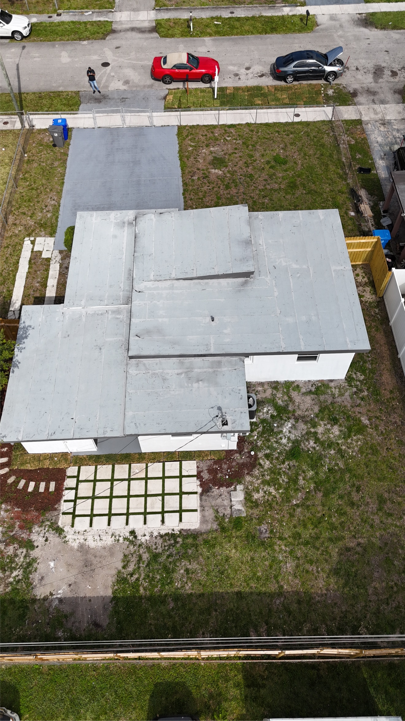 Aerial of a finished flat roof with gray cap sheet