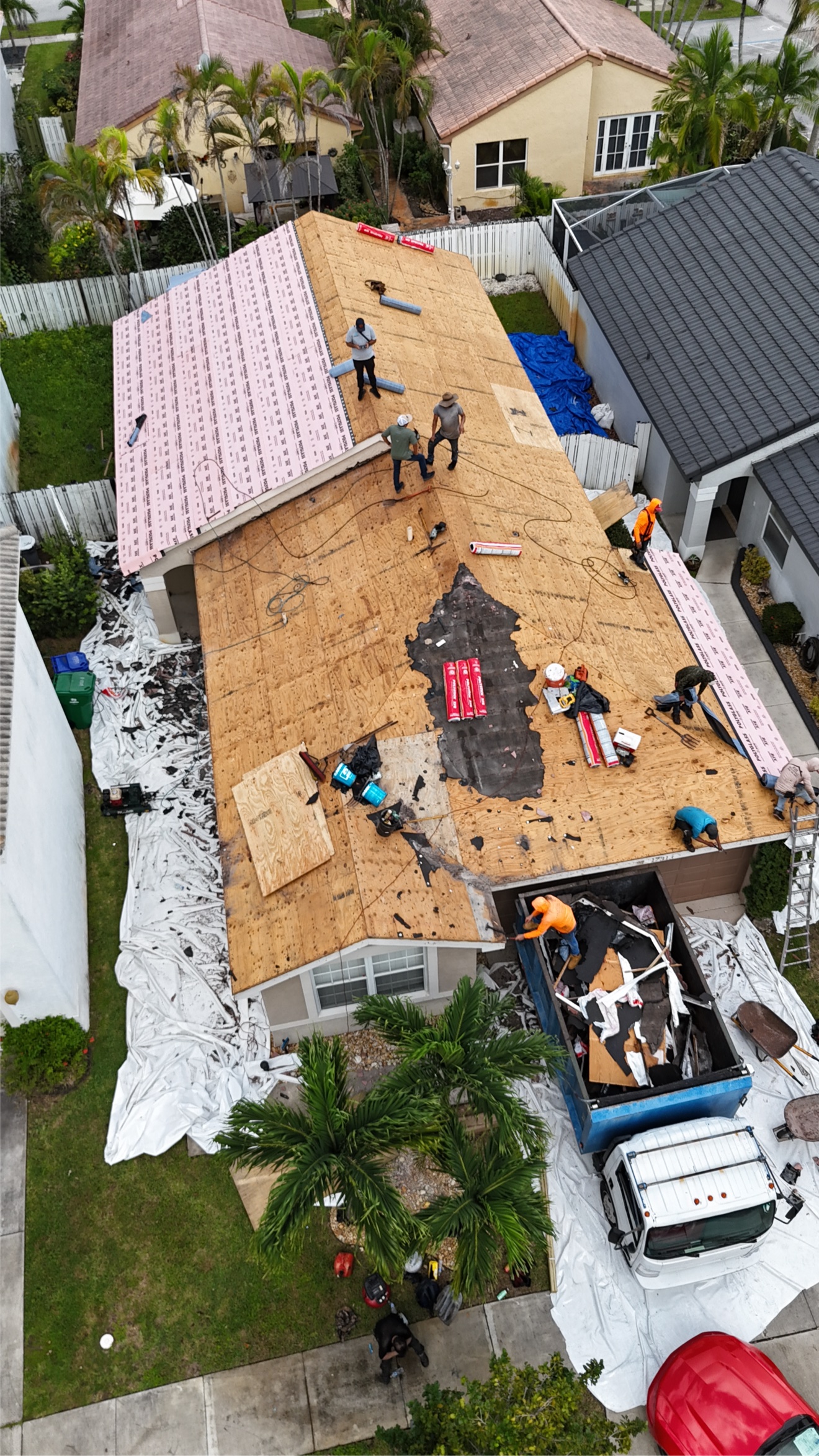 RE Builders crew installing a metal roof, aerial view