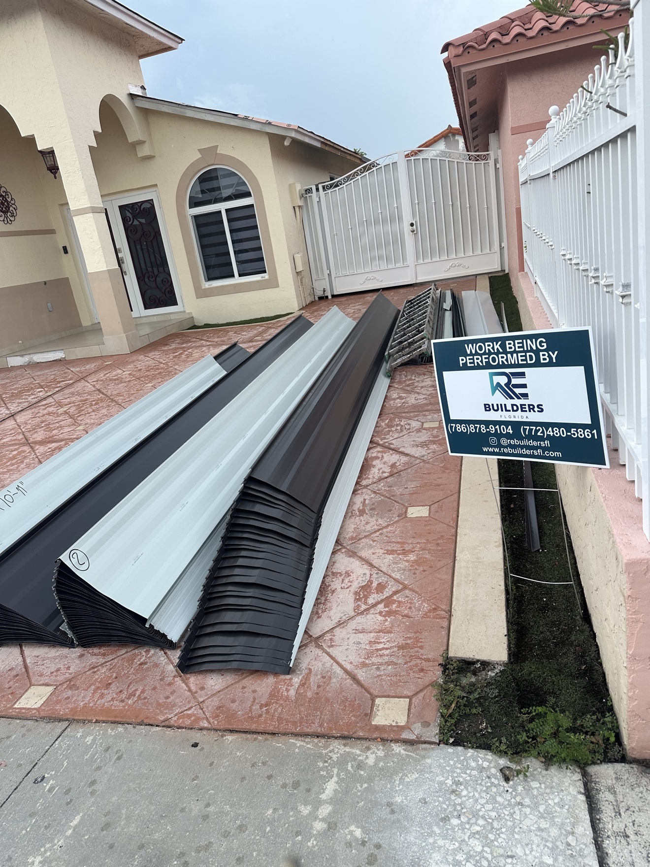 Metal panels delivered to the job site with RE Builders sign
