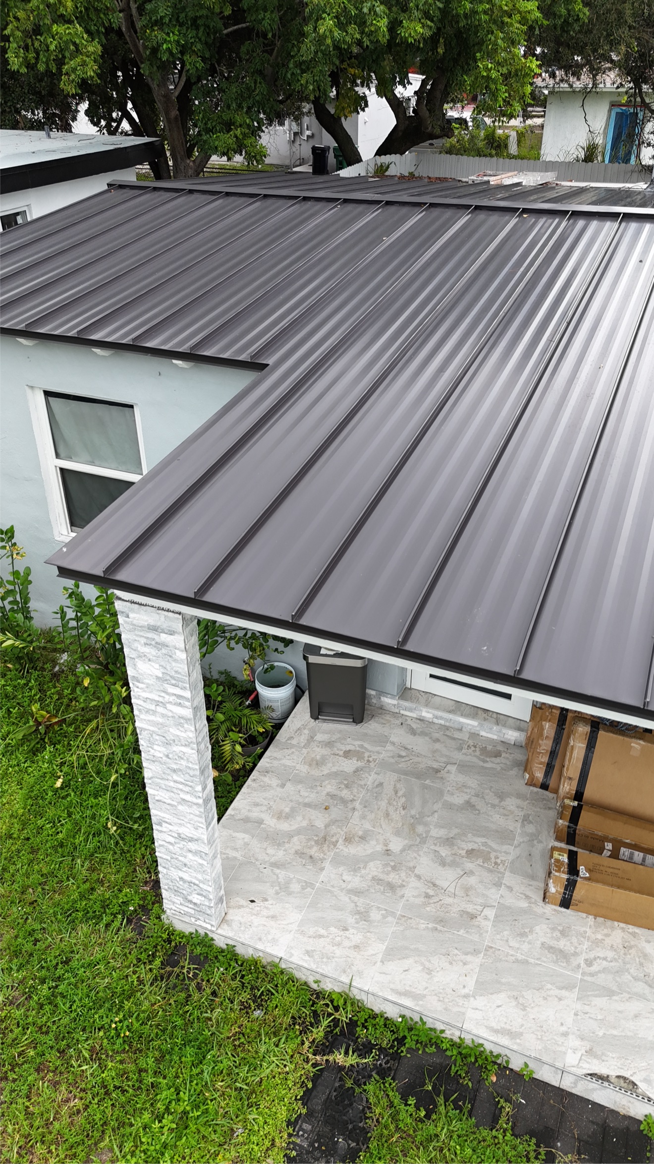 Aerial of completed metal roof with ladder