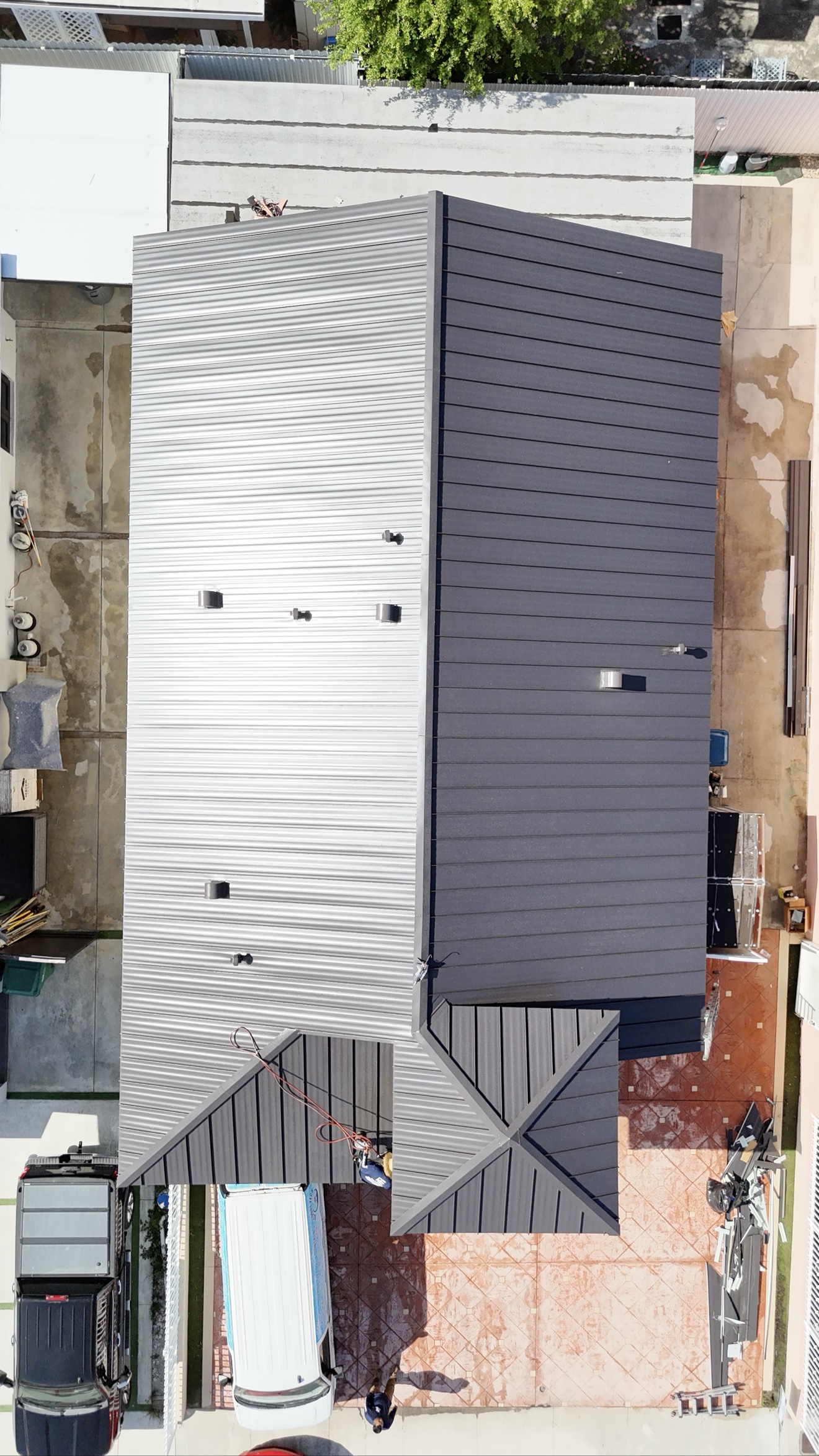 Aerial view of finished metal roof with ladder