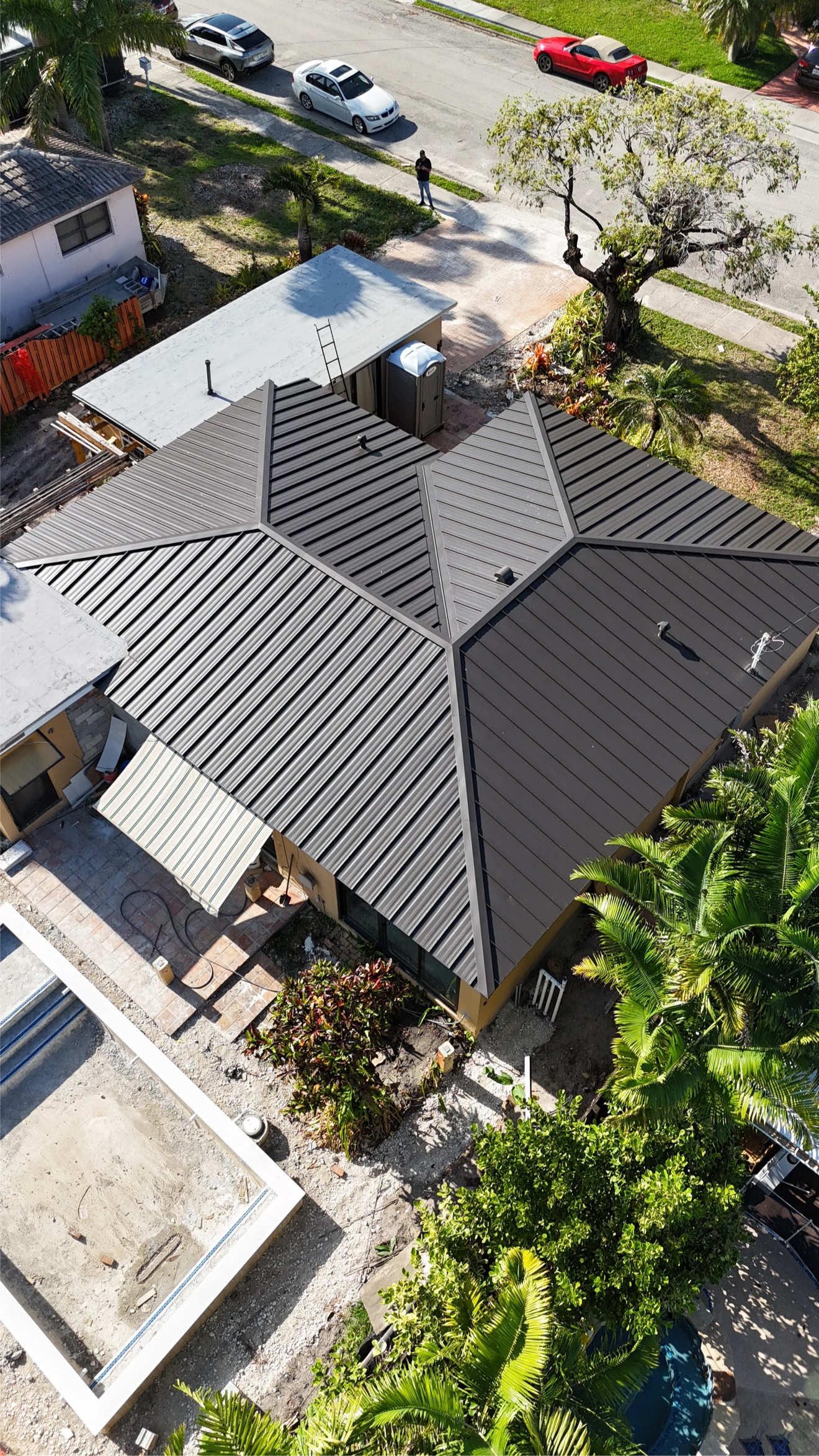 Aerial of a finished metal roof with pool and dock