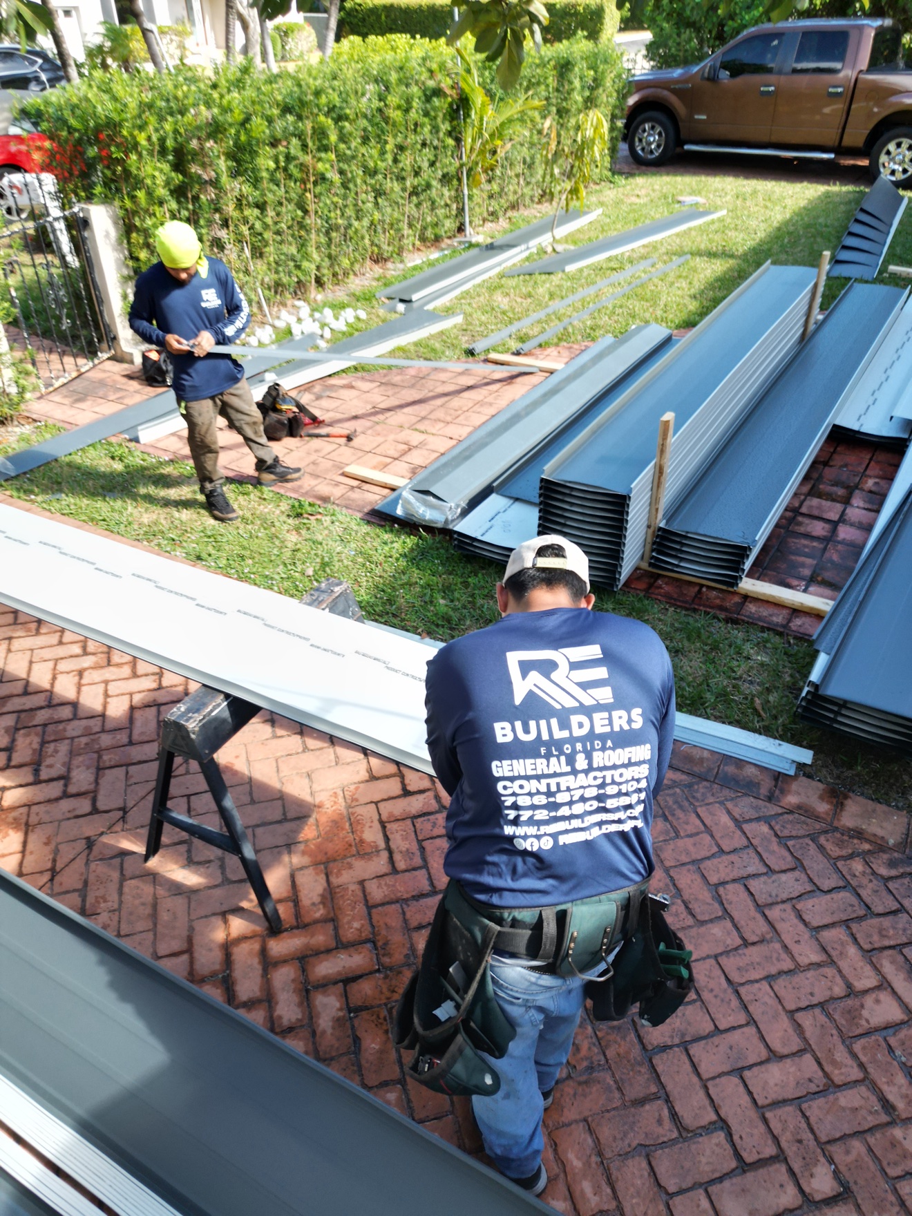 Aerial of metal roof sections with flat white roof