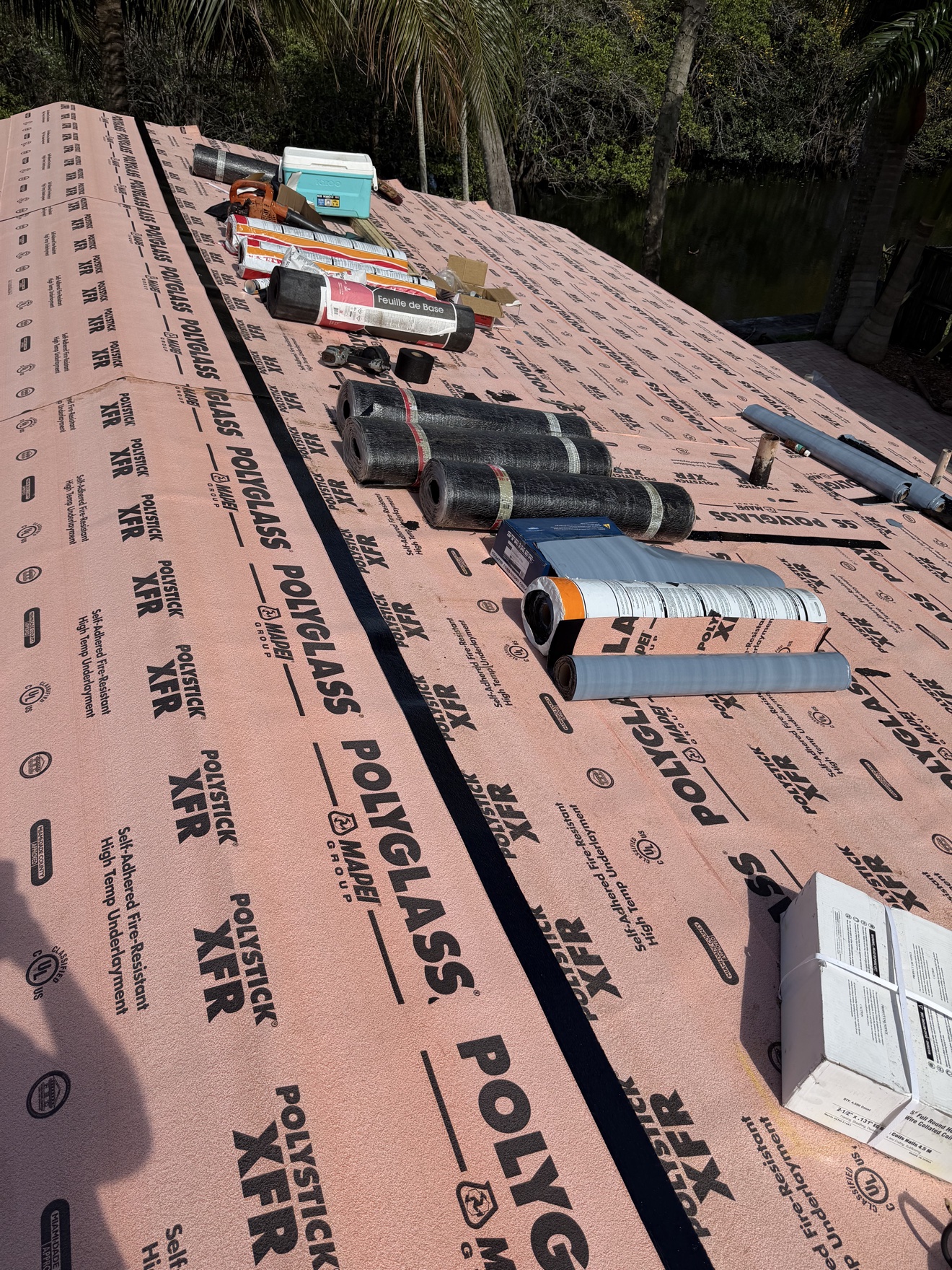 Underlayment down with materials staged for metal panel installation