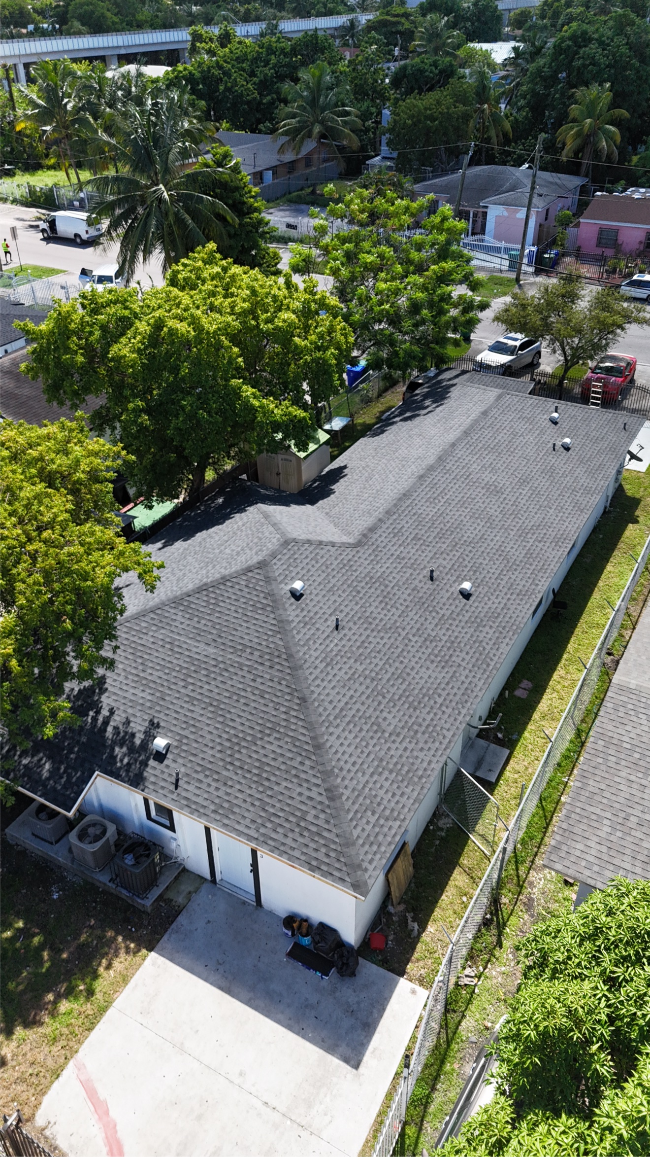 Aerial of a finished shingle roof on a white house