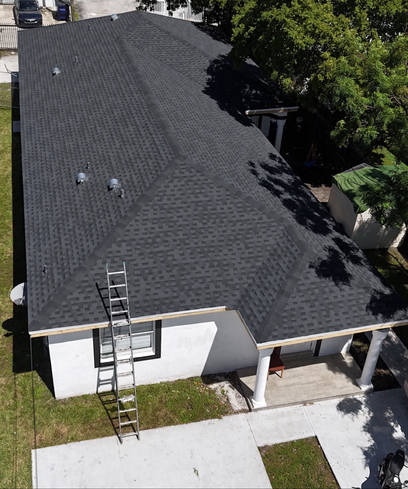 Top-down aerial of a finished shingle roof on a home