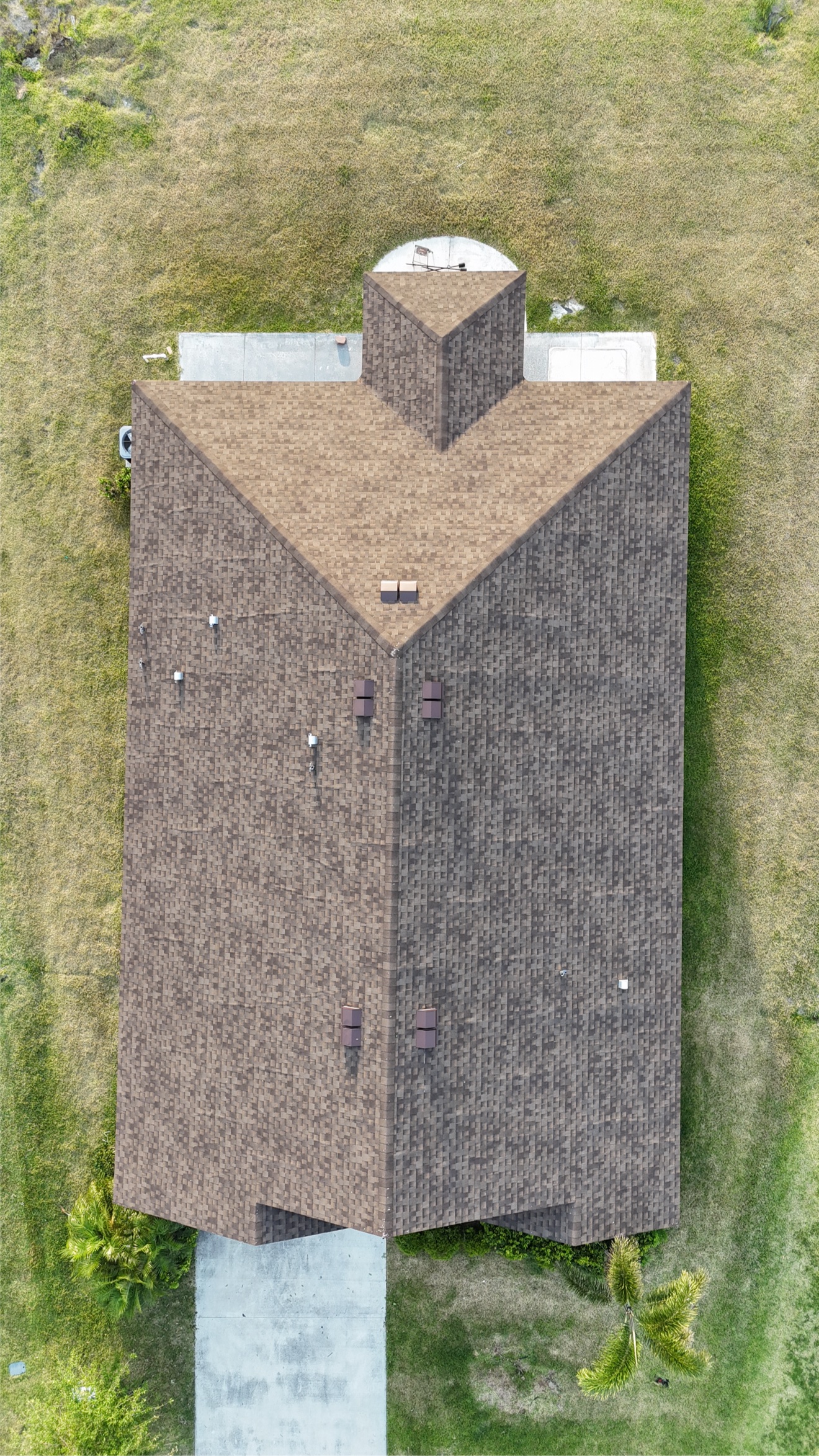 Top-down aerial of a finished brown shingle roof