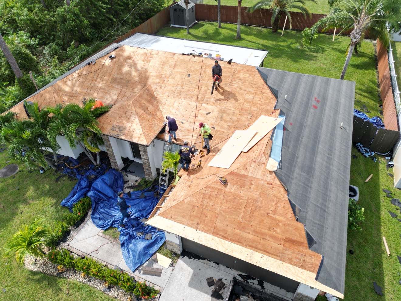 Aerial of a finished dark shingle roof on a white house