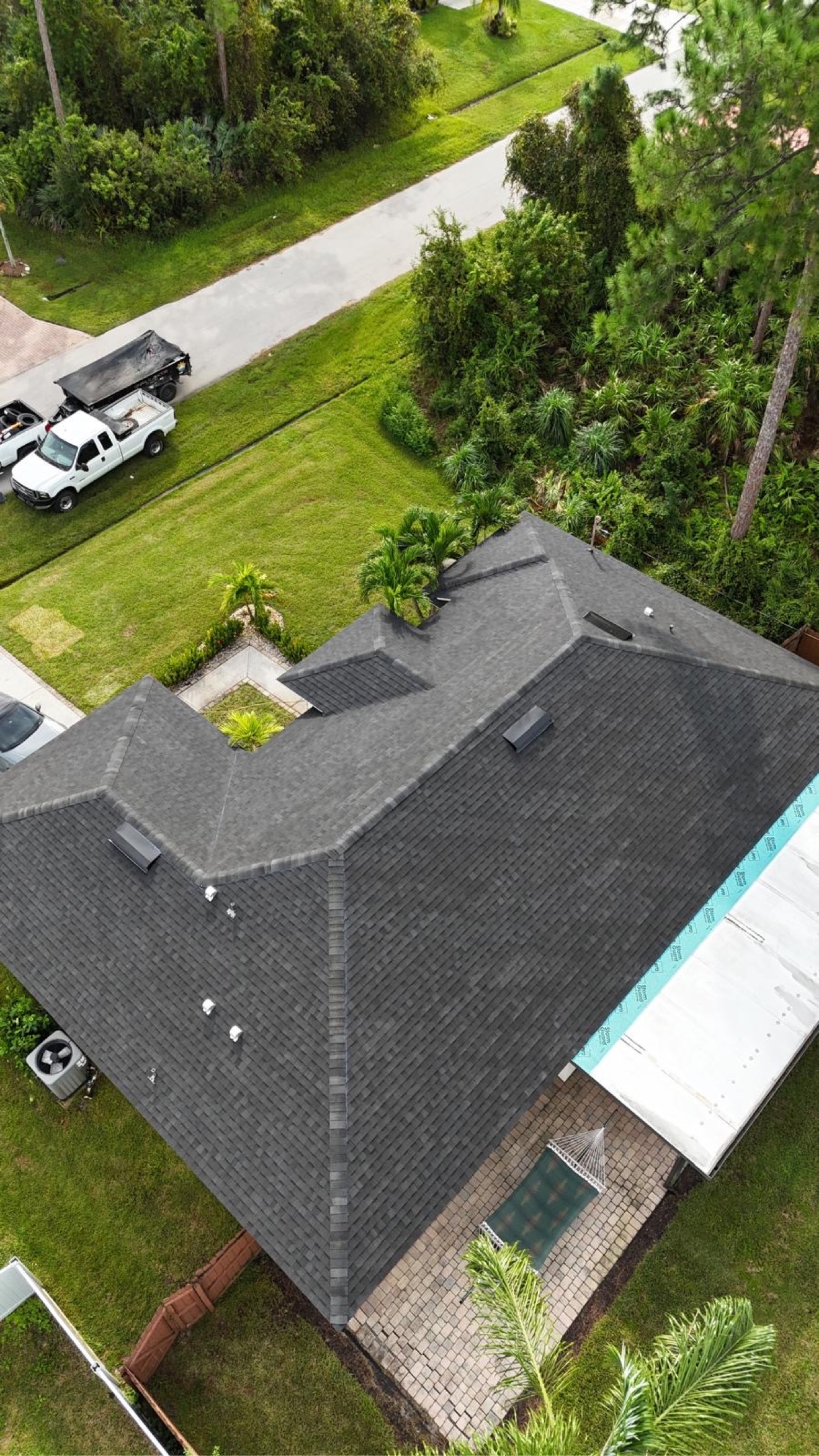 Aerial of a finished dark shingle roof on a home