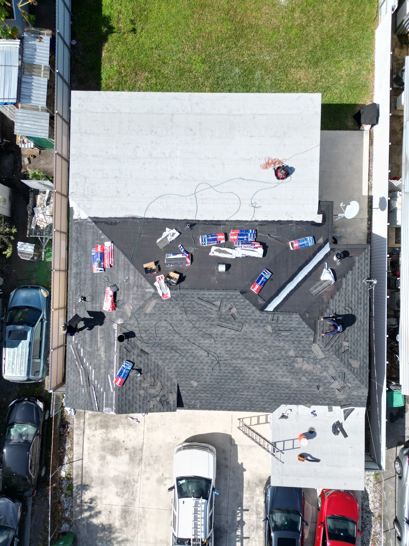 Aerial of a shingle job with GAF bundles staged