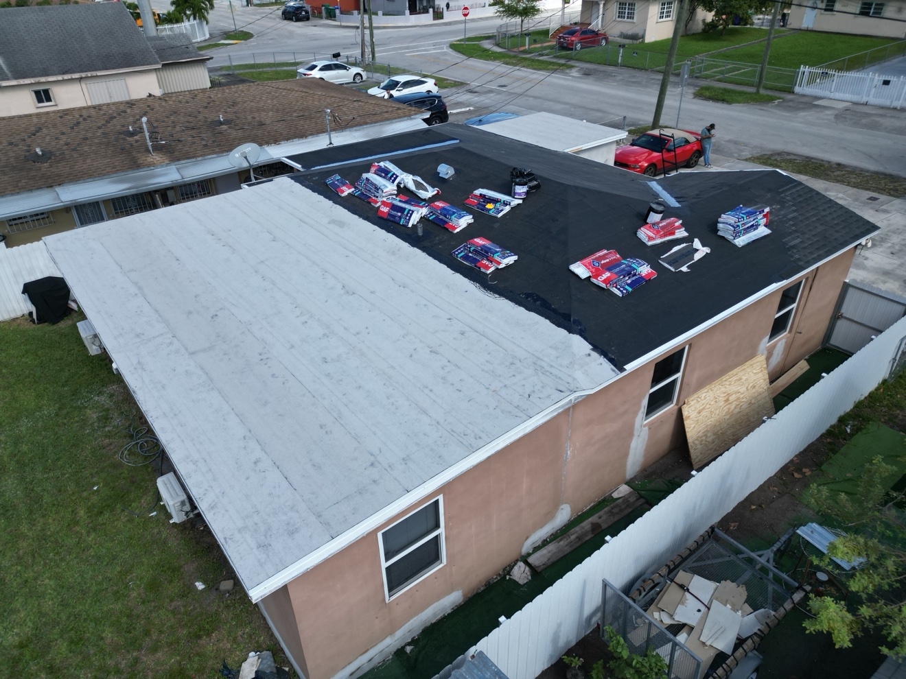 Aerial of a shingle and flat combo roof on a house