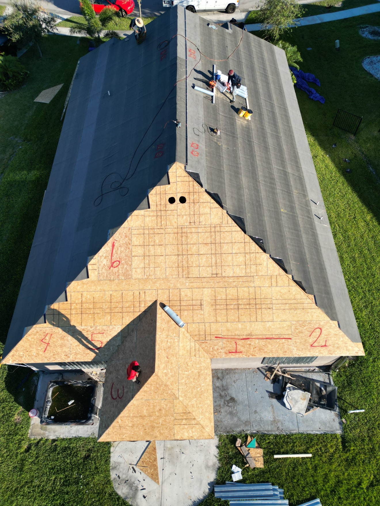Top-down aerial of shingle install in progress