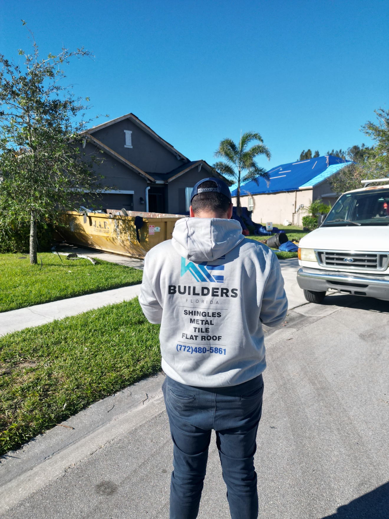 RE Builders Florida team member at a shingle job site