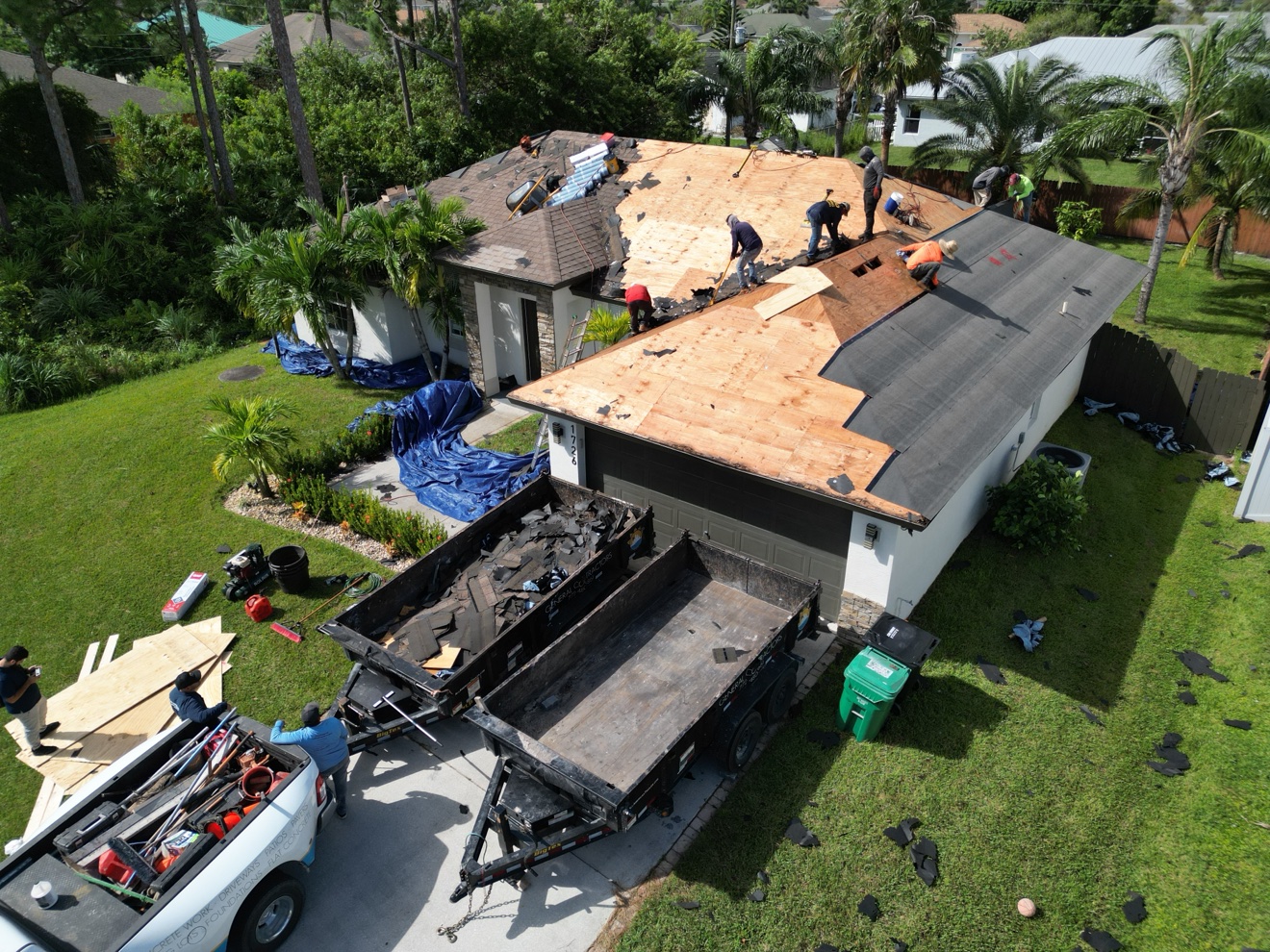 Aerial of shingle tear-off with a new plywood deck