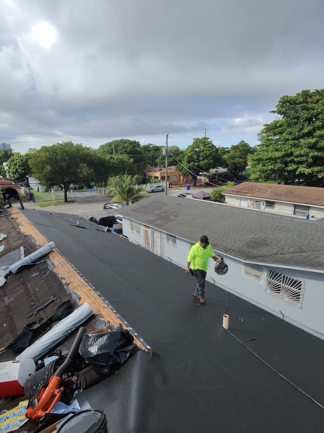 Worker on a shingle roof during underlayment install