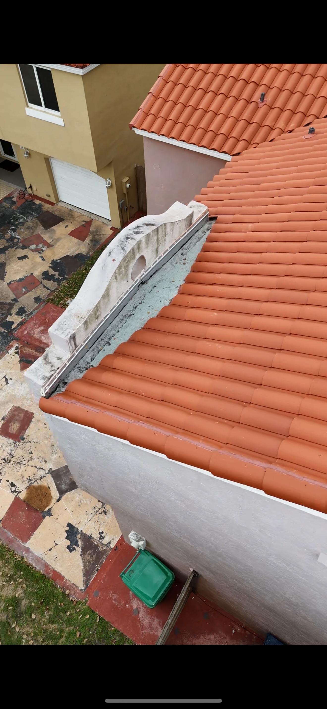 Aerial of a finished clay tile roof with AC unit