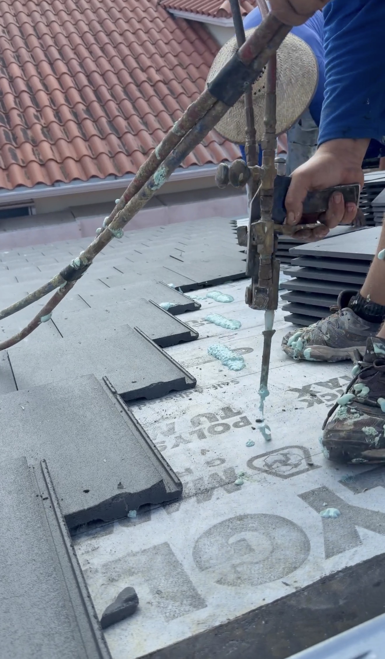 Close-up of flat concrete tiles and adhesive during installation