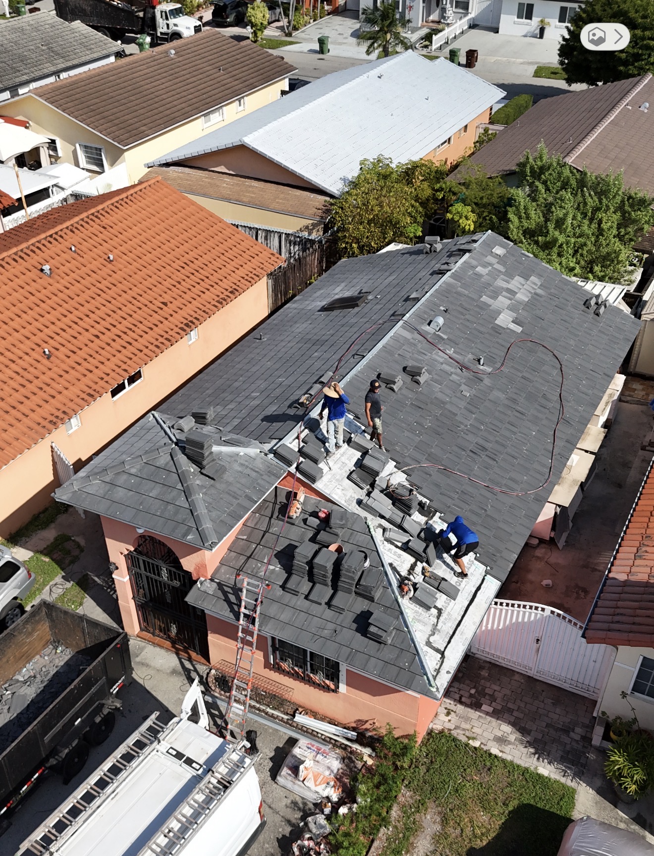 RE Builders crew installing a tile roof on a South Florida home