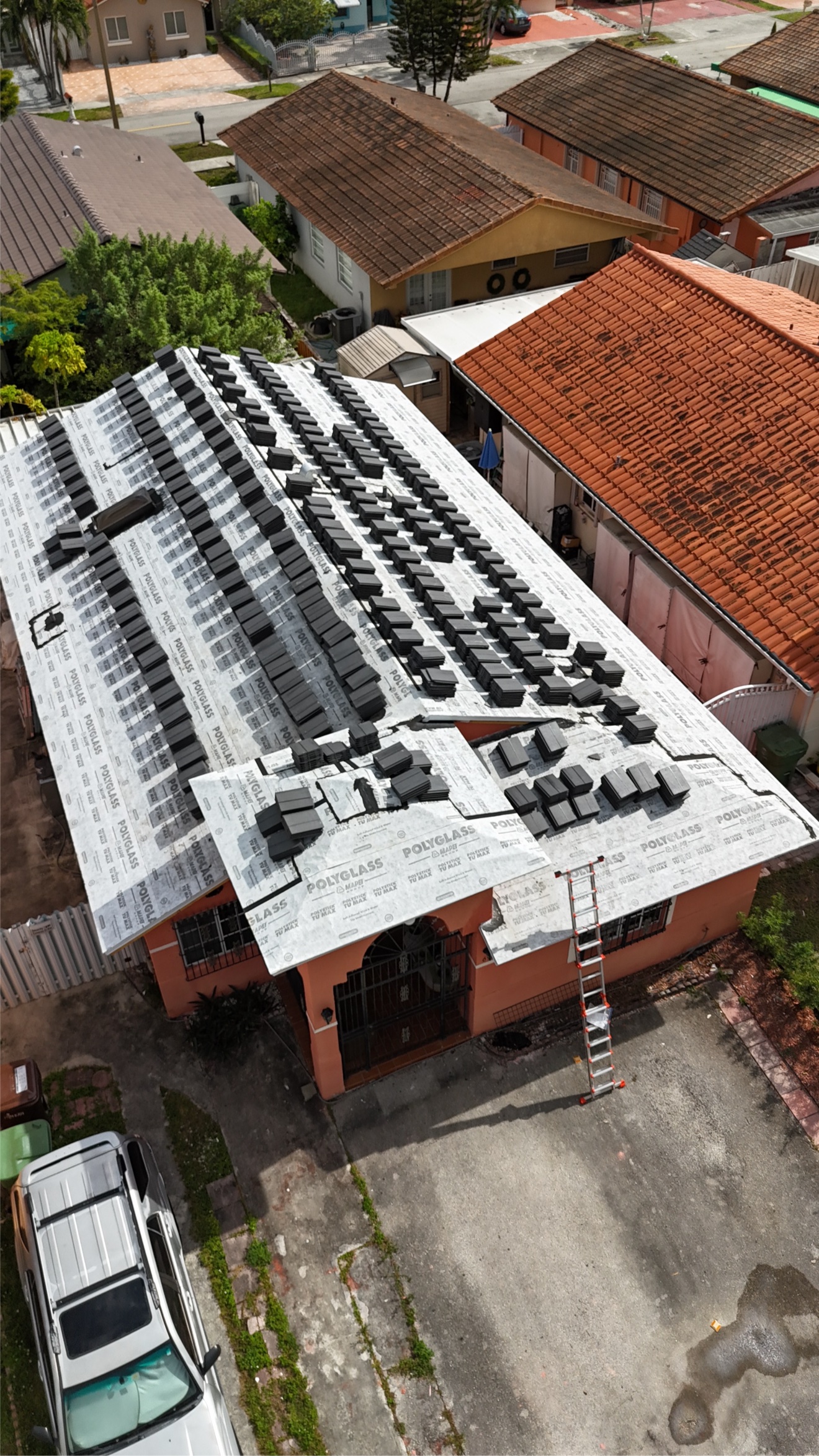 Aerial of tile installation in progress with crew