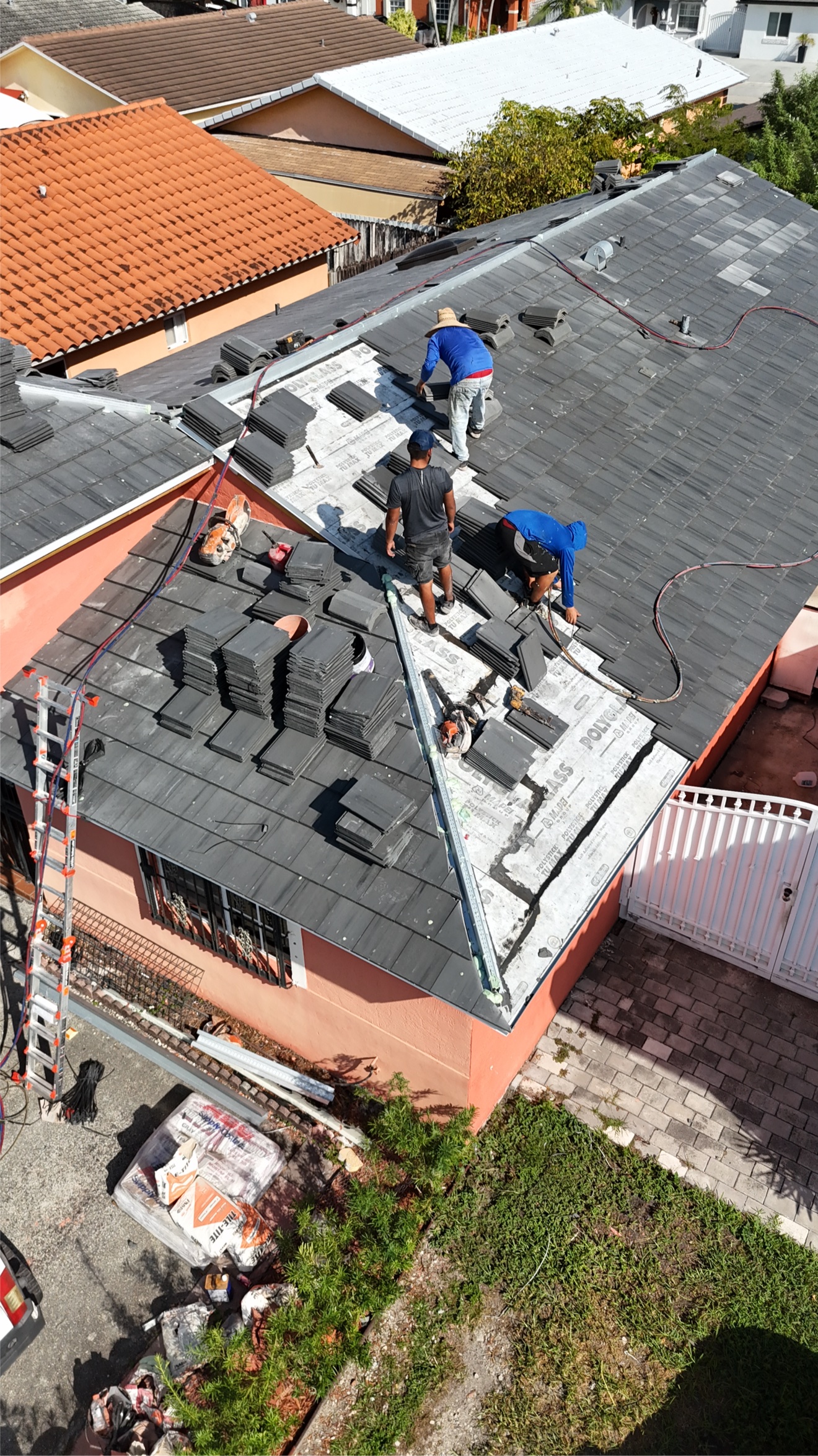 Aerial of crew installing flat tiles on Polyglass underlayment