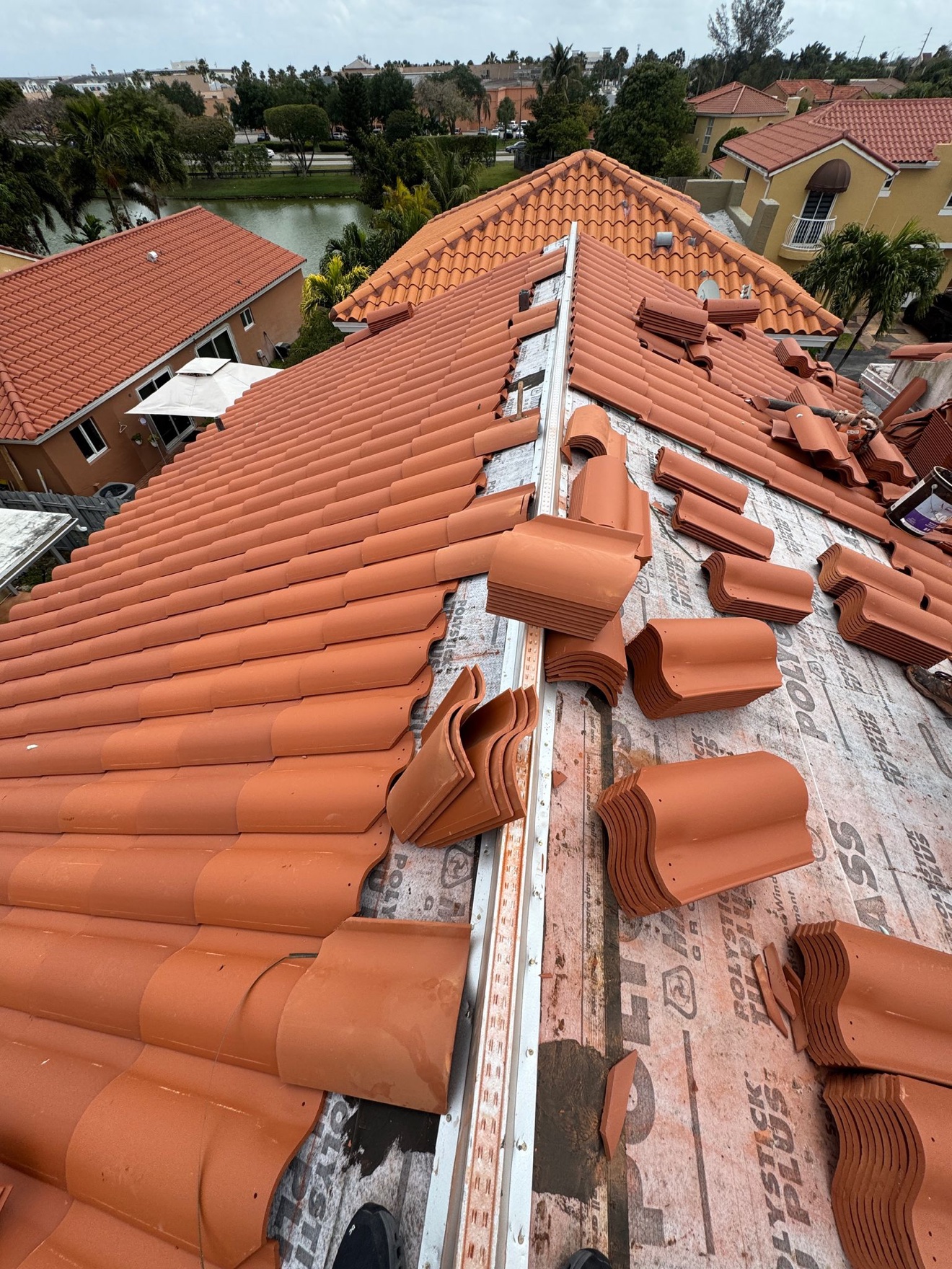 Aerial of clay tile installation with barrel tiles at the ridge