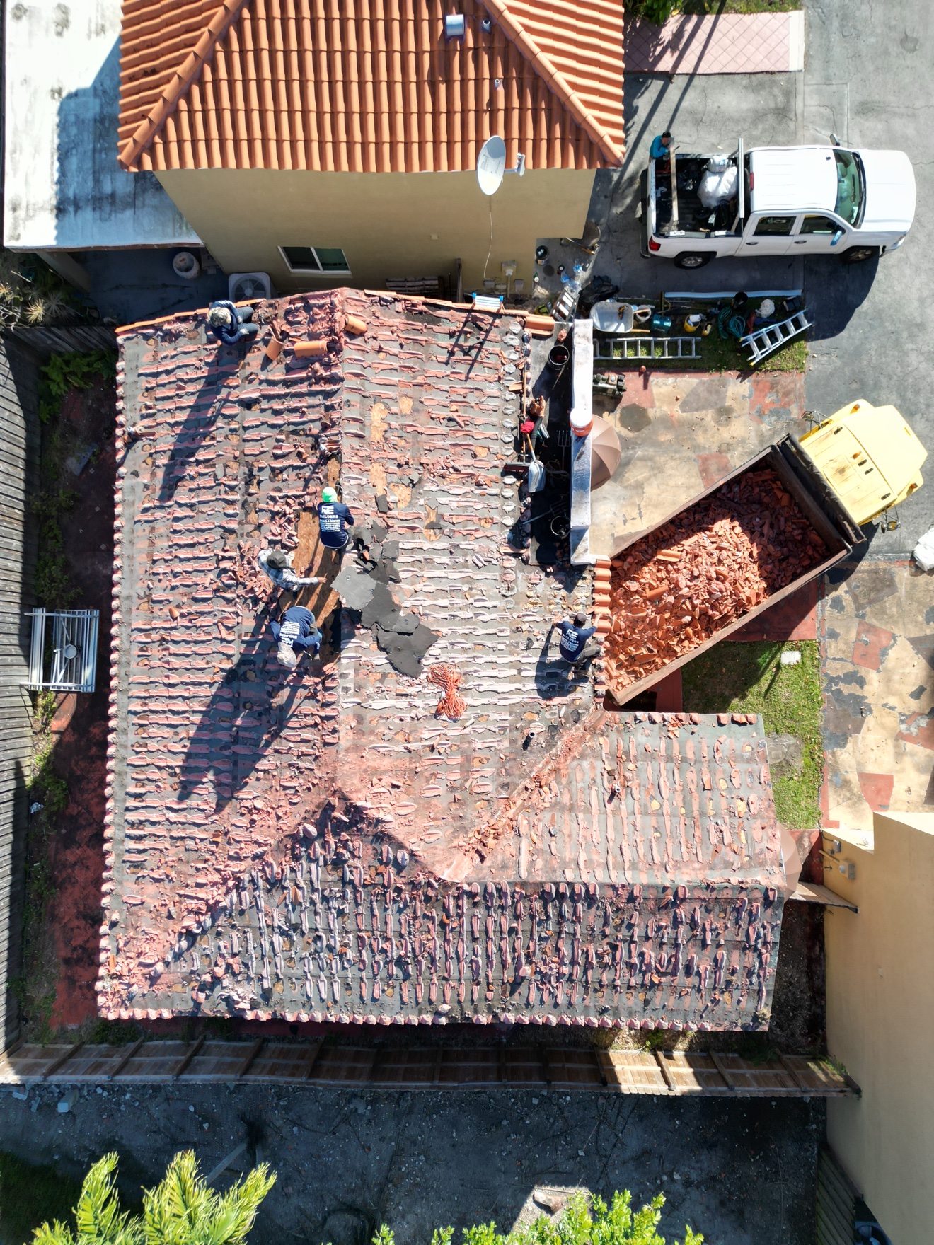 Aerial of new plywood deck with crew preparing underlayment