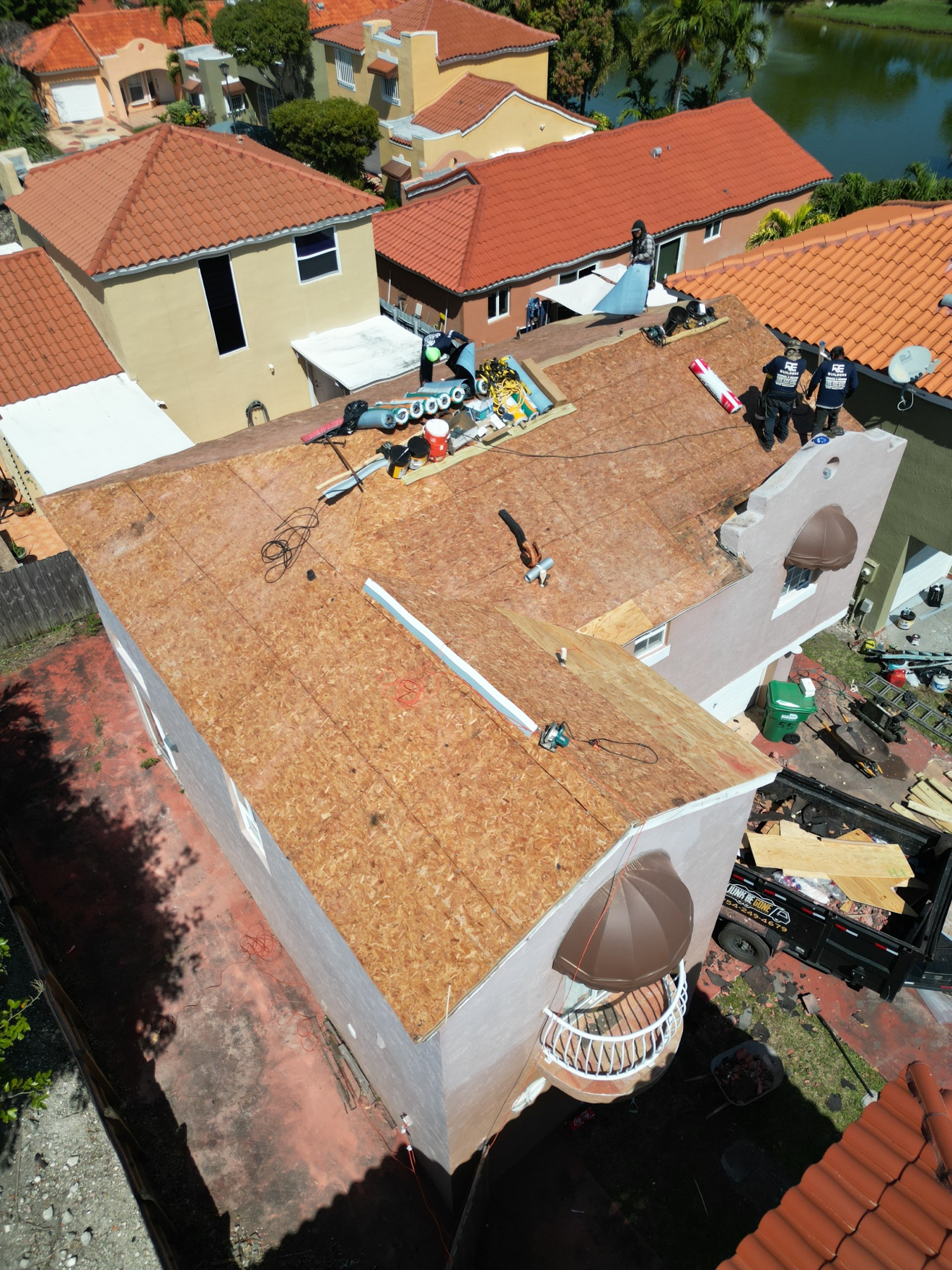 Aerial of new plywood deck with materials staged