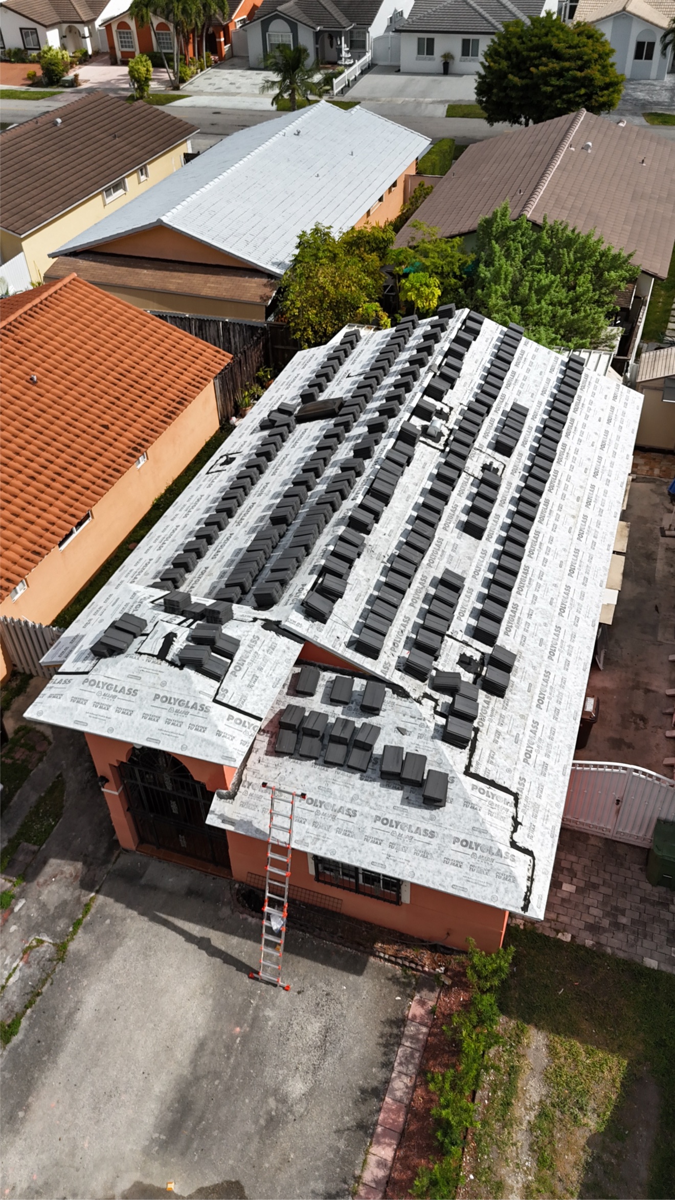 Aerial of tile stacks staged on underlayment