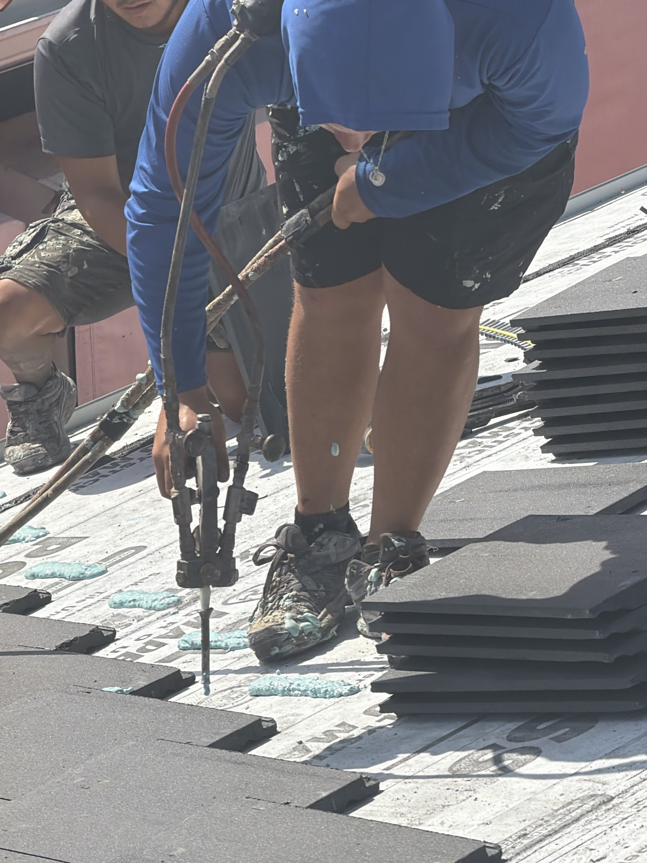 Top-down aerial of tile stacks on underlayment