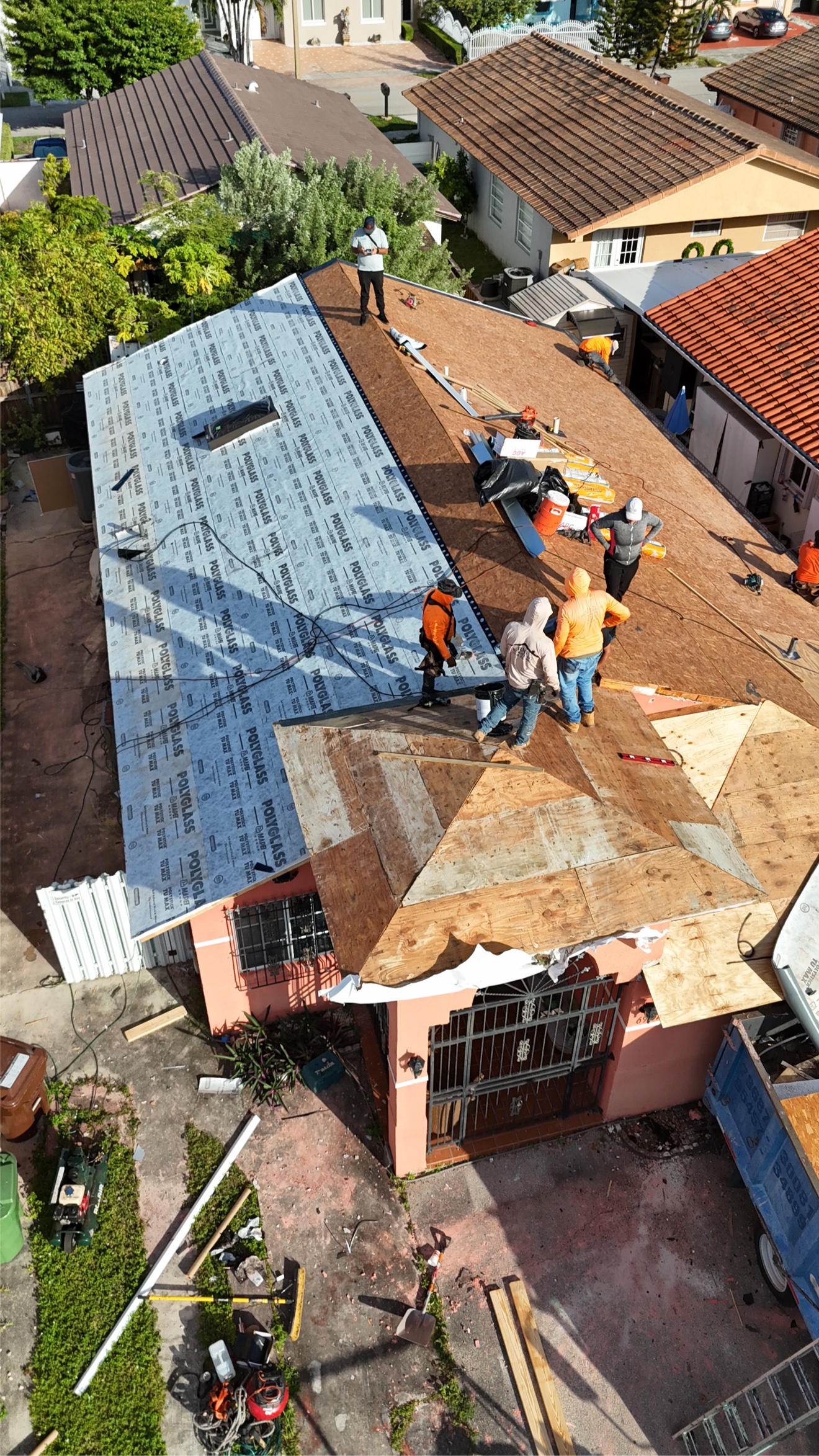 Crew installing Polyglass underlayment for tile roof