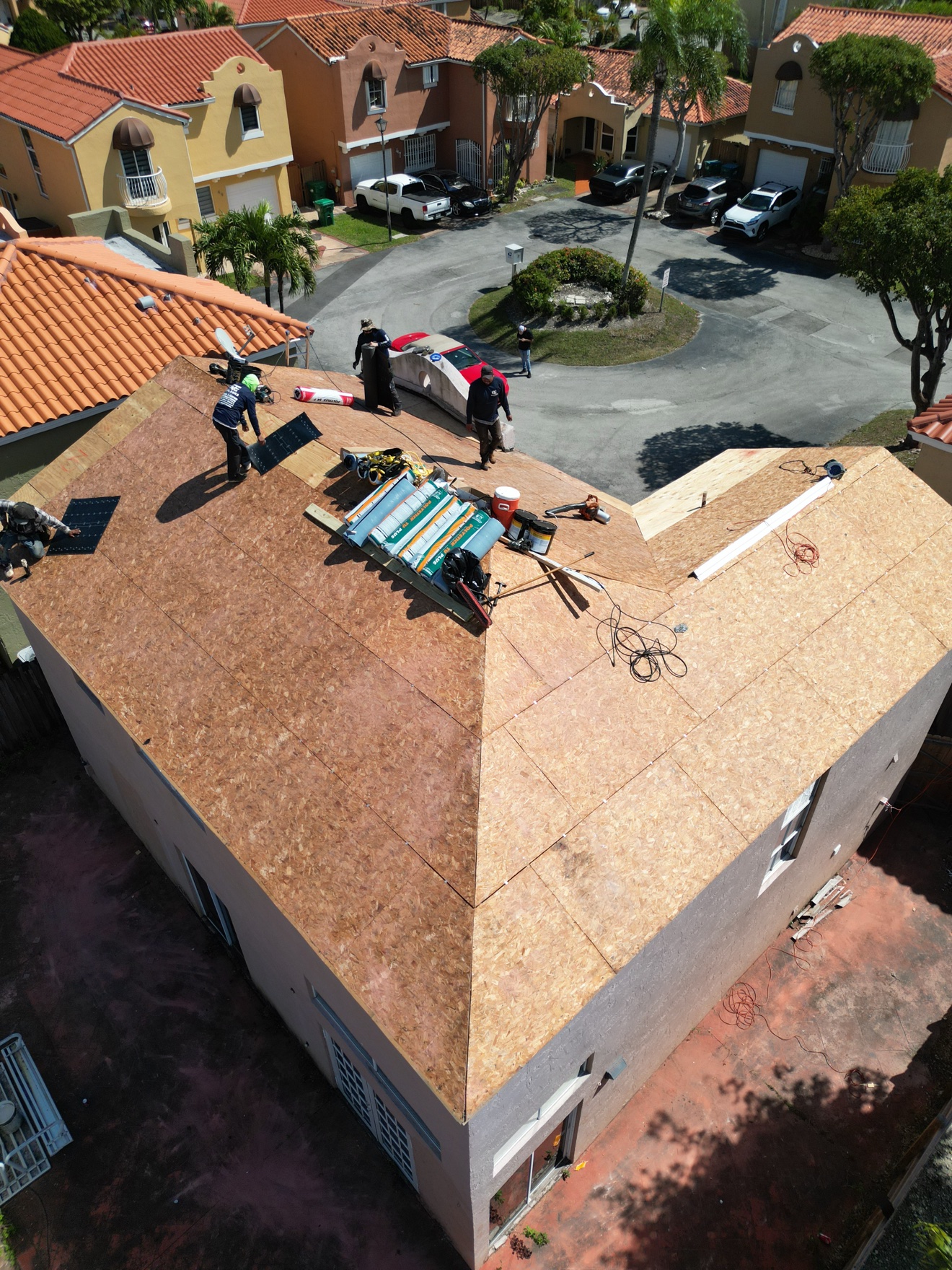 Aerial of crew installing underlayment on new deck