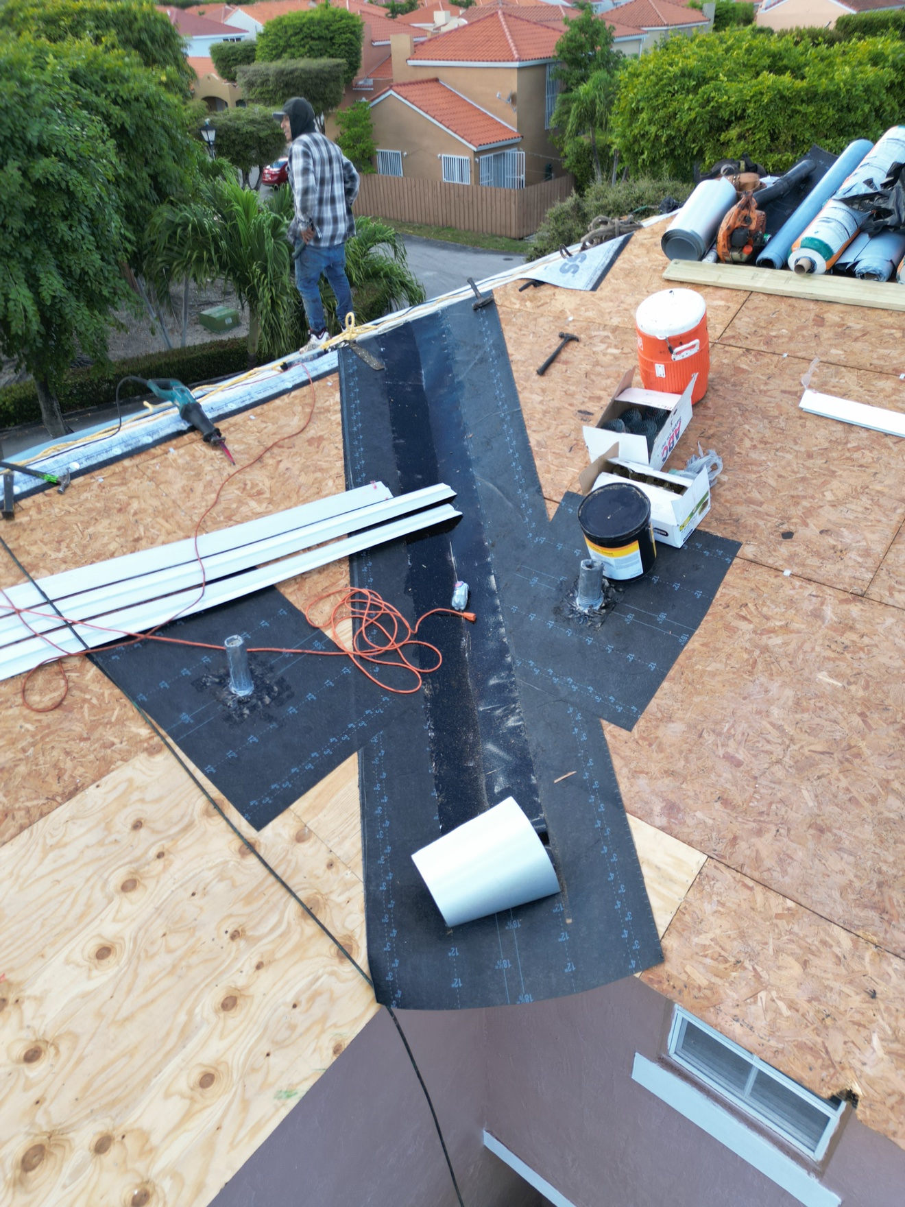 Aerial of plywood deck with underlayment strips at the valley